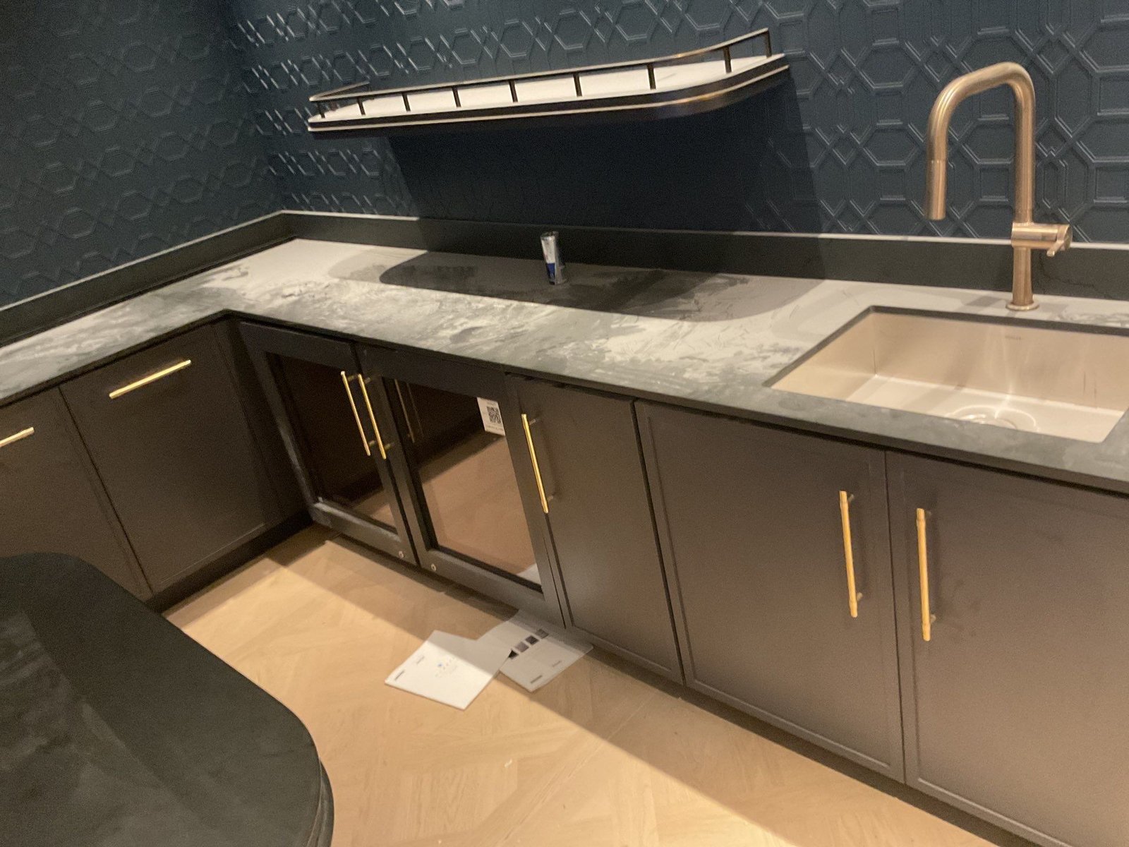 Capital One Arena suite charcoal wet bar with brass accents — NLI specialty install